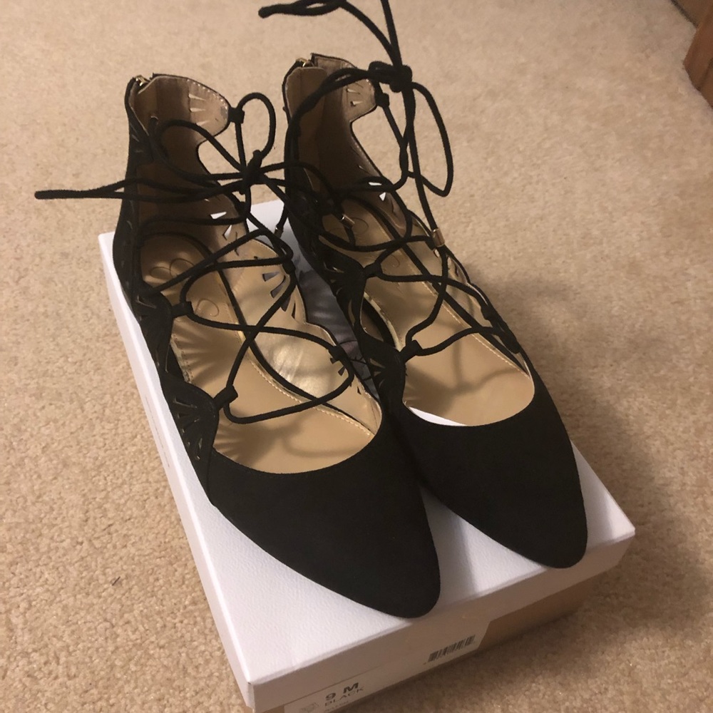 Black lace-up flats.
